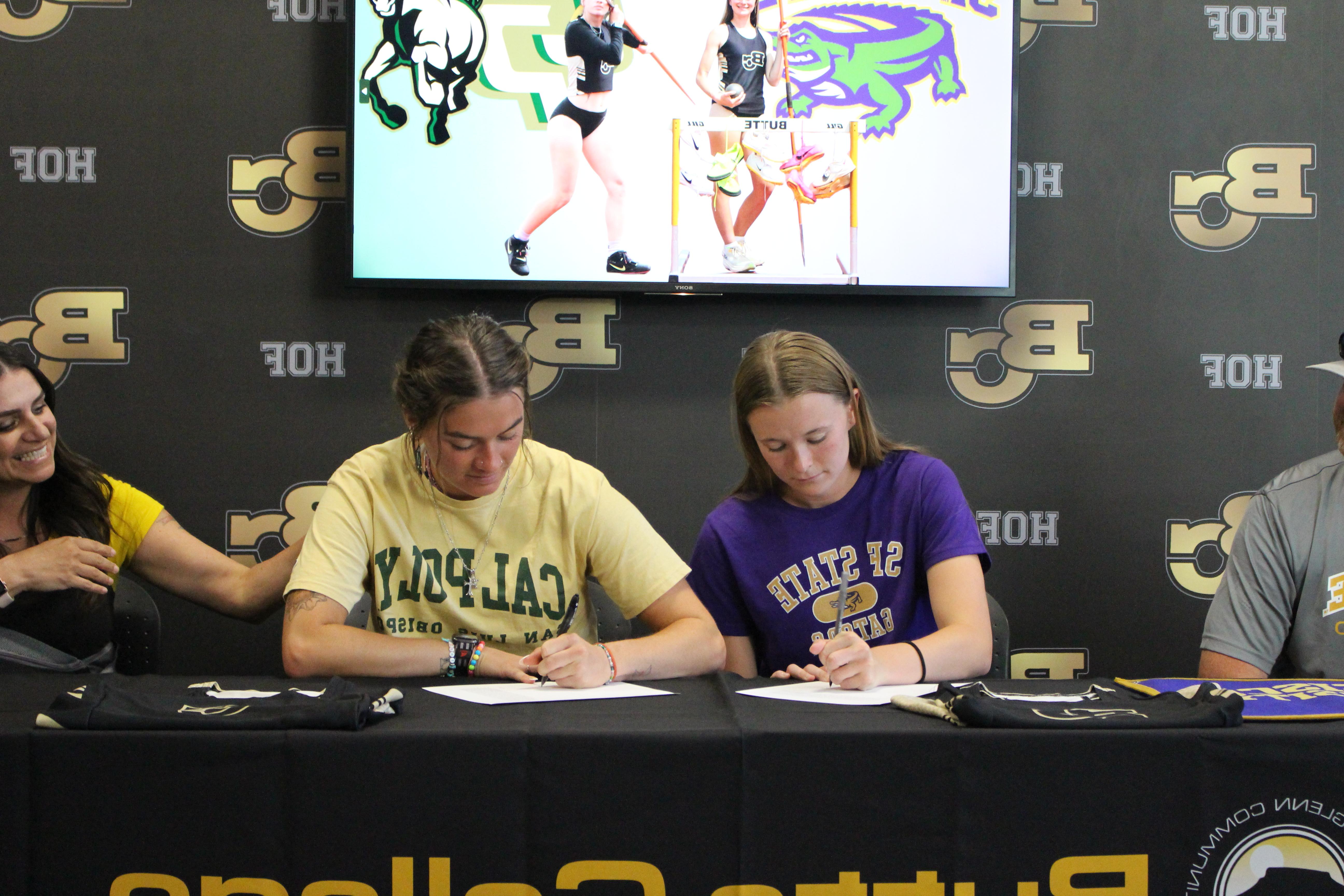 Julia and Talynn are shown signing their letters of intent. 